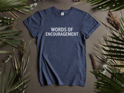 Navy t-shirt with white text "WORDS OF ENCOURAGEMENT" surrounded by foliage.