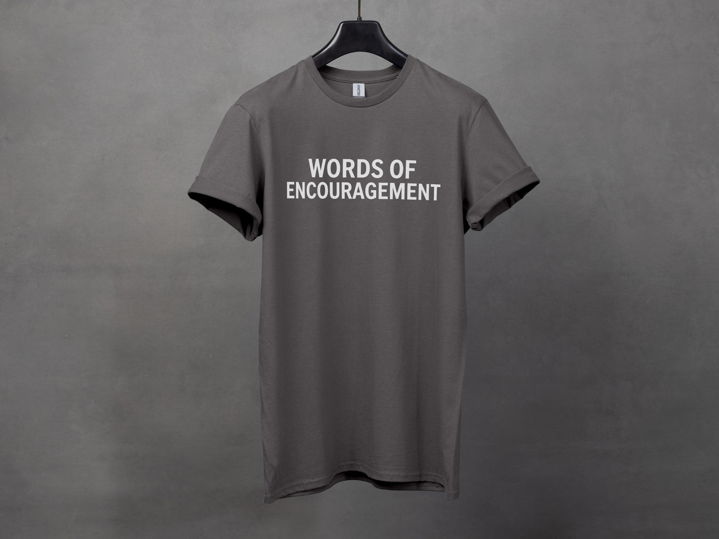 Dark grey t-shirt with "WORDS OF ENCOURAGEMENT" printed in white text.