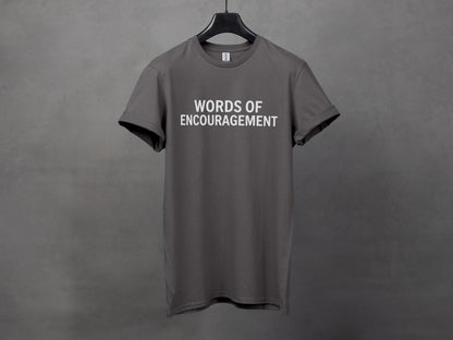 Dark grey t-shirt with "WORDS OF ENCOURAGEMENT" printed in white text.