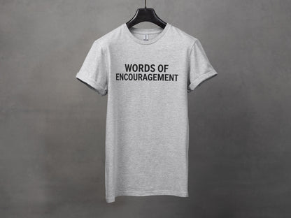 Grey t-shirt with "WORDS OF ENCOURAGEMENT" printed in black text.